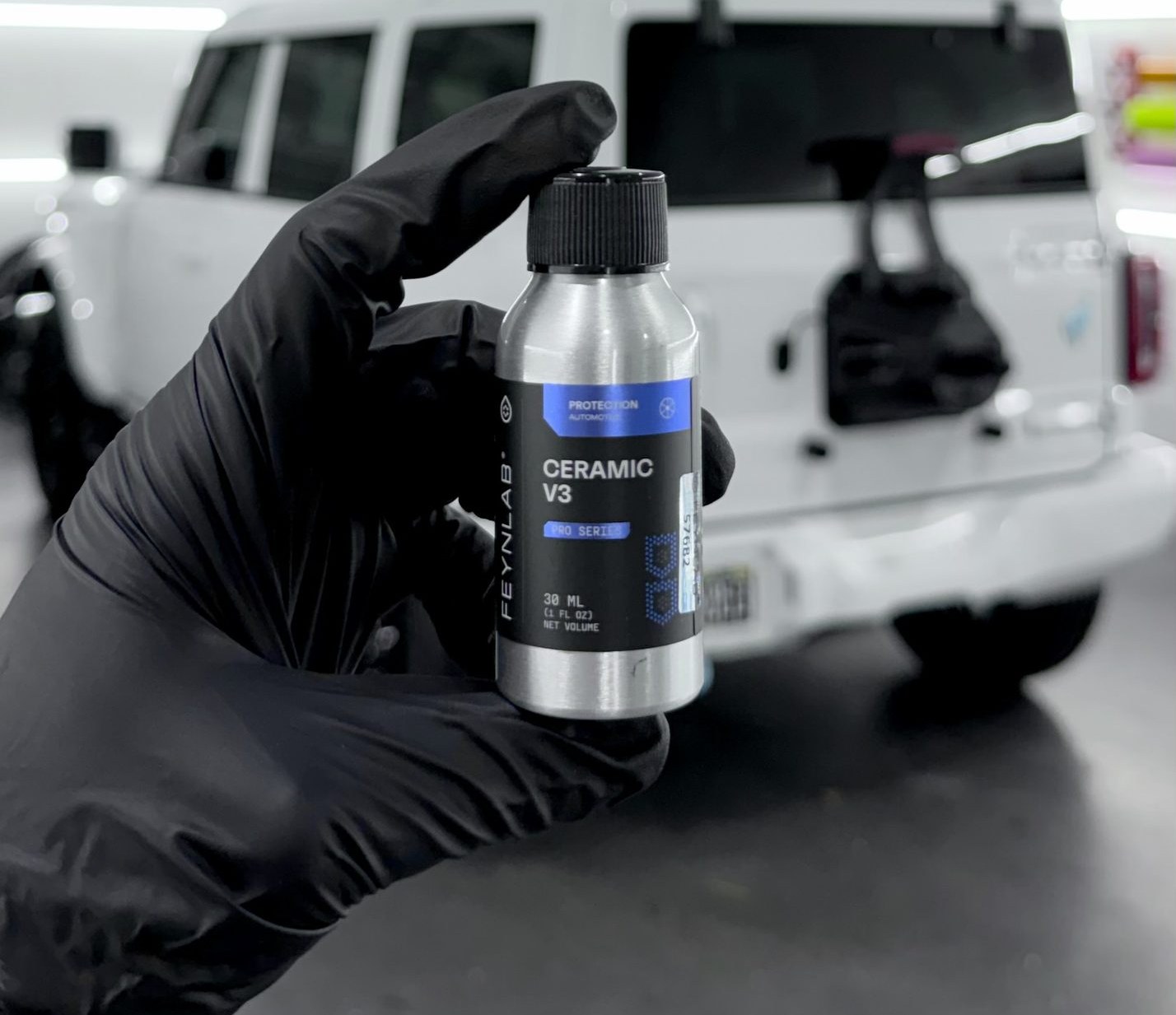 Feynlab ceramic coating being applied to a vehicle by Restyle Miami